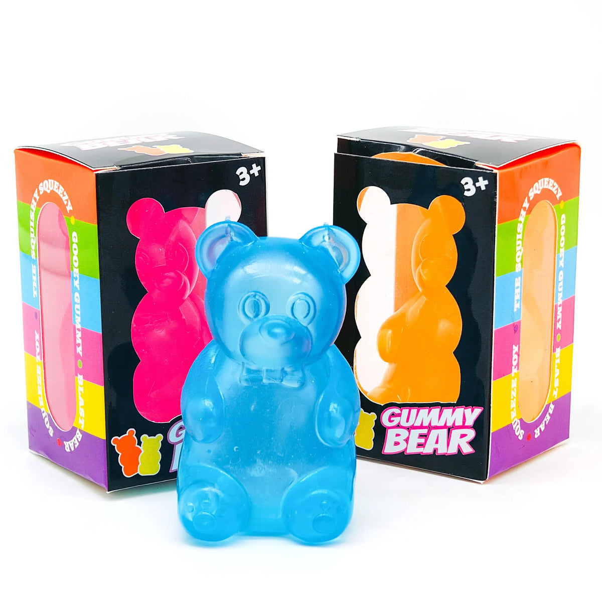 A blue gummy bear squeeze toy is shown in its box, with colorful packaging visible.