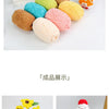 A collection of brightly colored soft chenille yarn balls in various shades including yellow, orange, pink, and teal.