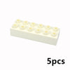 Un bloc rectangulaire blanc contenant cinq petits blocs de construction ronds et auto-bloquants pour enfants.