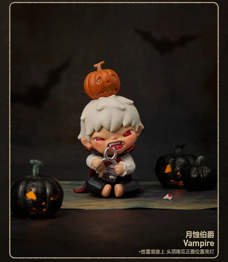 A collectible figure of a vampire with white hair and orange skin, holding a silver locket, standing in front of carved pumpk