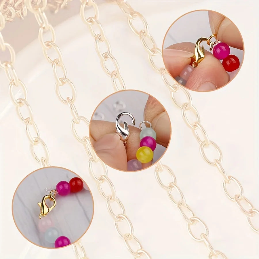 Close-up view of gold lobster clasps and open jump rings for jewelry making, shown on a delicate chain.