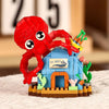 A red crab figure is positioned on a blue building block structure featuring sea life elements.