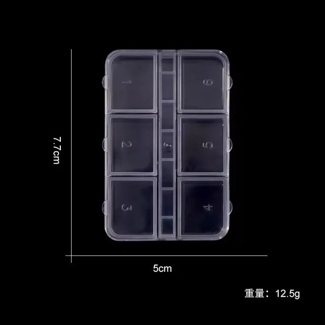 Clear nail art storage case with compartments for various rhinestones and tools