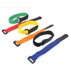 A set of five nylon bike handlebar straps in green, yellow, red, orange, and blue.