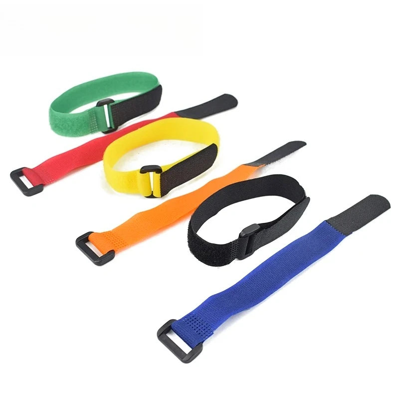 A set of five nylon bike handlebar straps in green, yellow, red, orange, and blue.