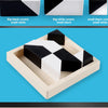 A geometric block puzzle featuring black and white blocks arranged in a light wood storage tray.