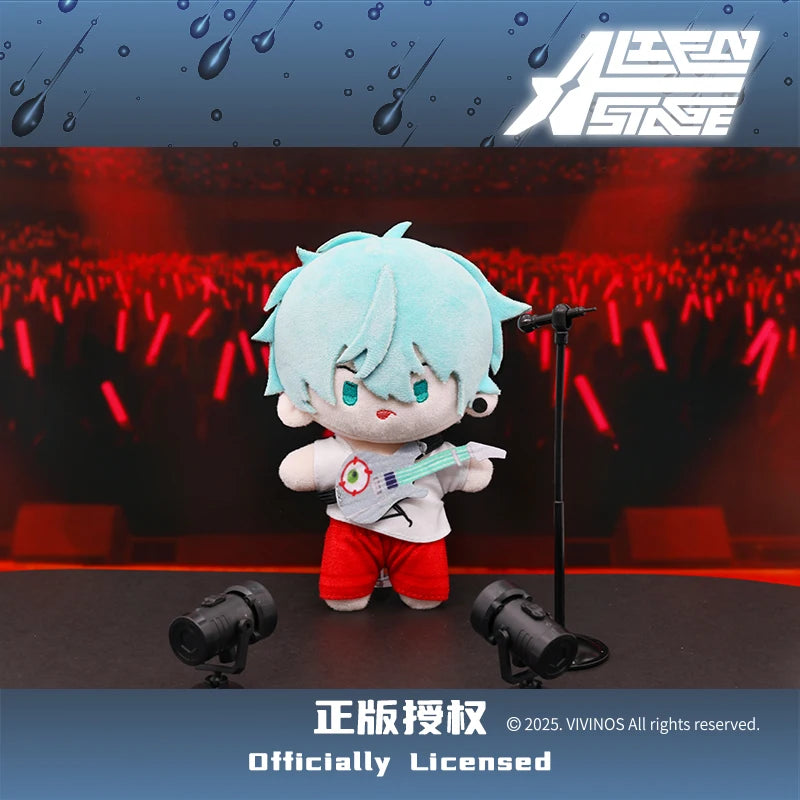 A light blue plush doll resembling a character from Alien Stage is standing on a stage with red lights in the background.