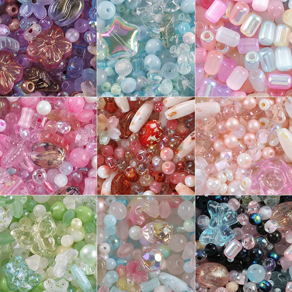 A collection of colorful crystal glass spacer beads in various shades including pink, purple, blue, and clear.