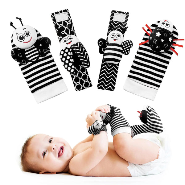 A set of black and white striped plush baby rattles and foot socks for newborns.