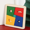 A wooden tangram puzzle set with colored geometric shapes on a light wood background.
