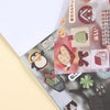 A close-up of a sticker book featuring various kawaii embroidery-style designs and patterns.