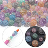 A collection of round loose glitter cracked acrylic beads in various colors including pink, purple, blue, and gold.