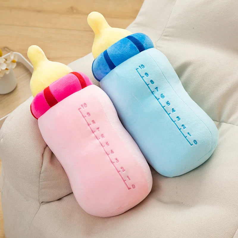 A soft cartoon boba milk bottle plush pillow with yellow and blue accents resting on a light fabric surface.
