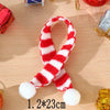 A red and white striped knitted hat and scarf set for dolls displayed on a wooden surface.