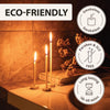 Natural beeswax taper candles displayed on a surface with labels indicating they are eco-friendly, smokeless, and free of par