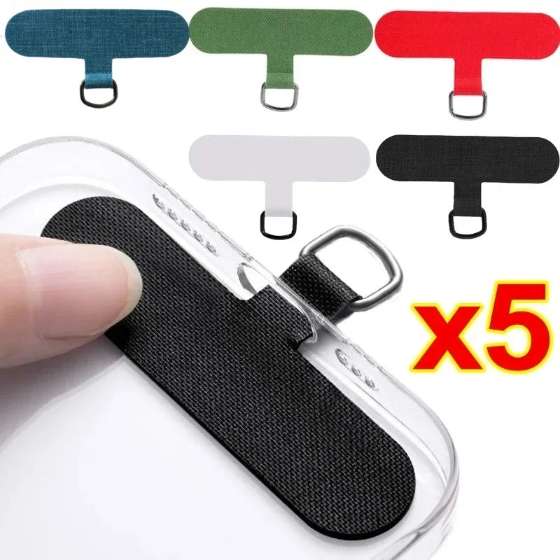Five detachable lanyard straps in various colors and black strap on a clear phone case.