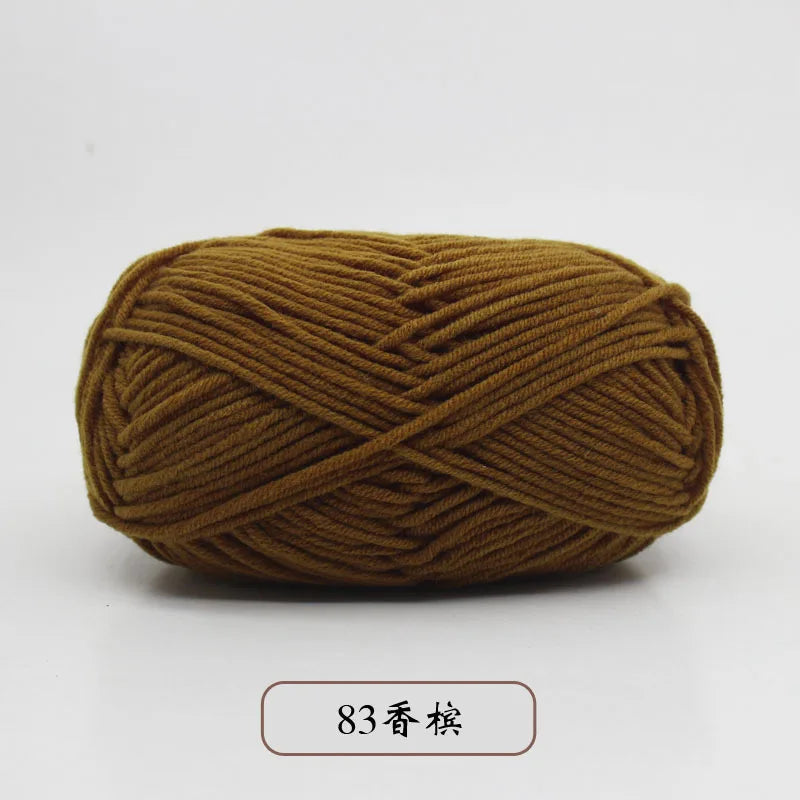 A ball of olive brown pre-dyed milk cotton yarn, 50g, used for knitting and crochet.