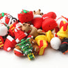 A collection of red and white silicone beads shaped like Santa figures, reindeer, and Christmas trees for craft jewelry.