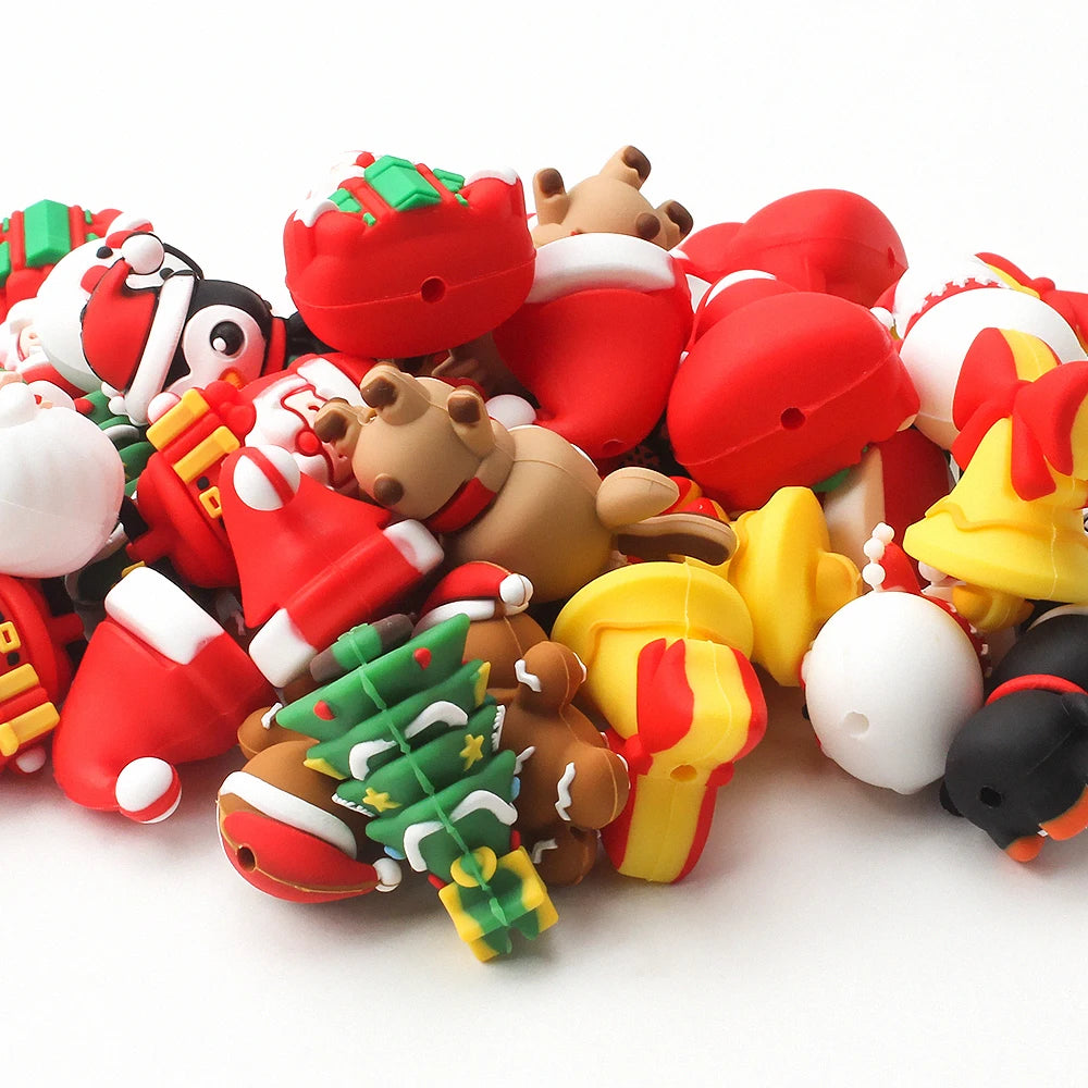 A collection of red and white silicone beads shaped like Santa figures, reindeer, and Christmas trees for craft jewelry.