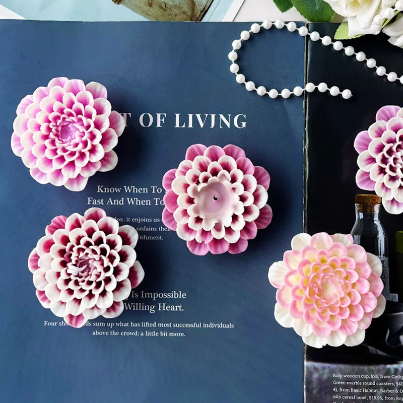 Pink flower silicone mold for crafting with a white beaded necklace and green bottle