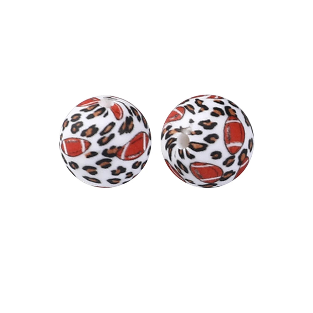 Pair of spherical silicone beads with a leopard print design and an orange fruit pattern.