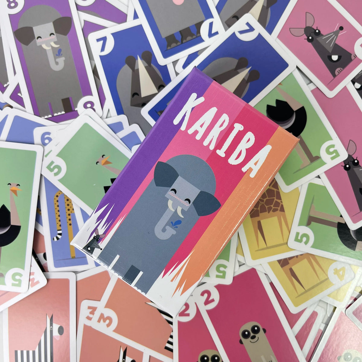 A collection of colorful cards featuring illustrations of elephants and other animals for a board game set