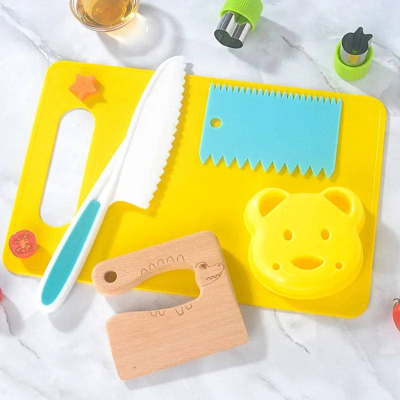 A yellow cutting board holds a white knife, a blue plastic ruler, and a wooden cookie cutter, with a green tool visible nearb