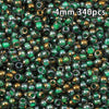 A close-up view of 340 golden gradient glass beads with green accents.