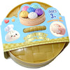 A set of squishy dumplings toys in various colors and shapes with a wooden tray and packaging.