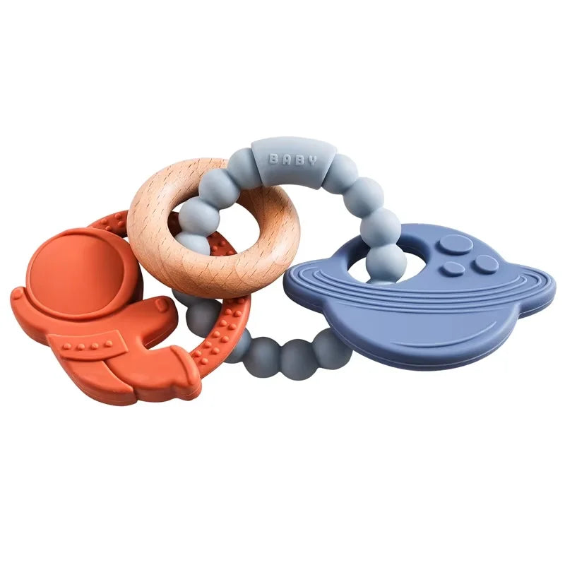 A set of food-grade silicone planet teethers for babies in orange, wood, and blue colors.