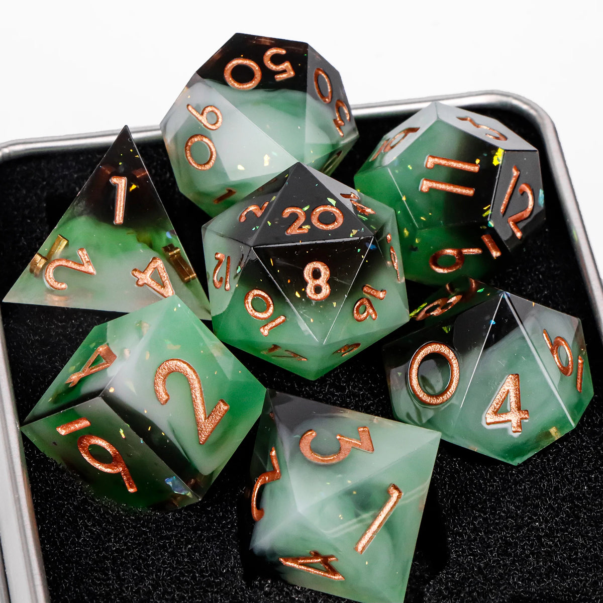 A collection of green resin polyhedral dice, including a d10 and d20, displayed on a black surface.