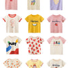 A collection of ten short-sleeve cotton t-shirts for girls featuring various seasonal and fruit prints like cherry, summer, l