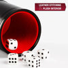 A black leather dice cup with a red interior and five white dice on a white surface.