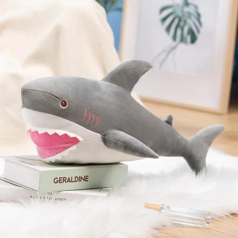 A gray and pink plush stuffed animal depicting a killer whale and great white shark.