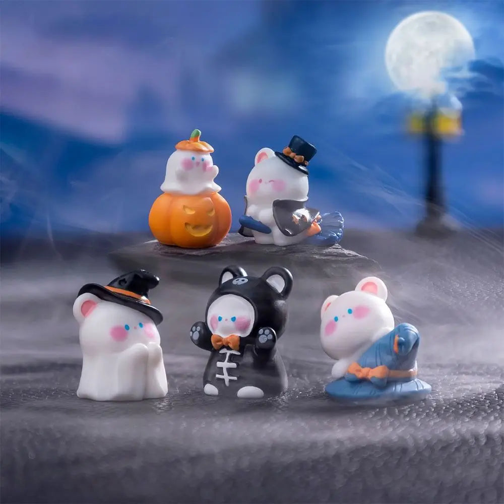 A collection of charming cartoon bear and pumpkin figurines in various colors and styles displayed on a dark surface.