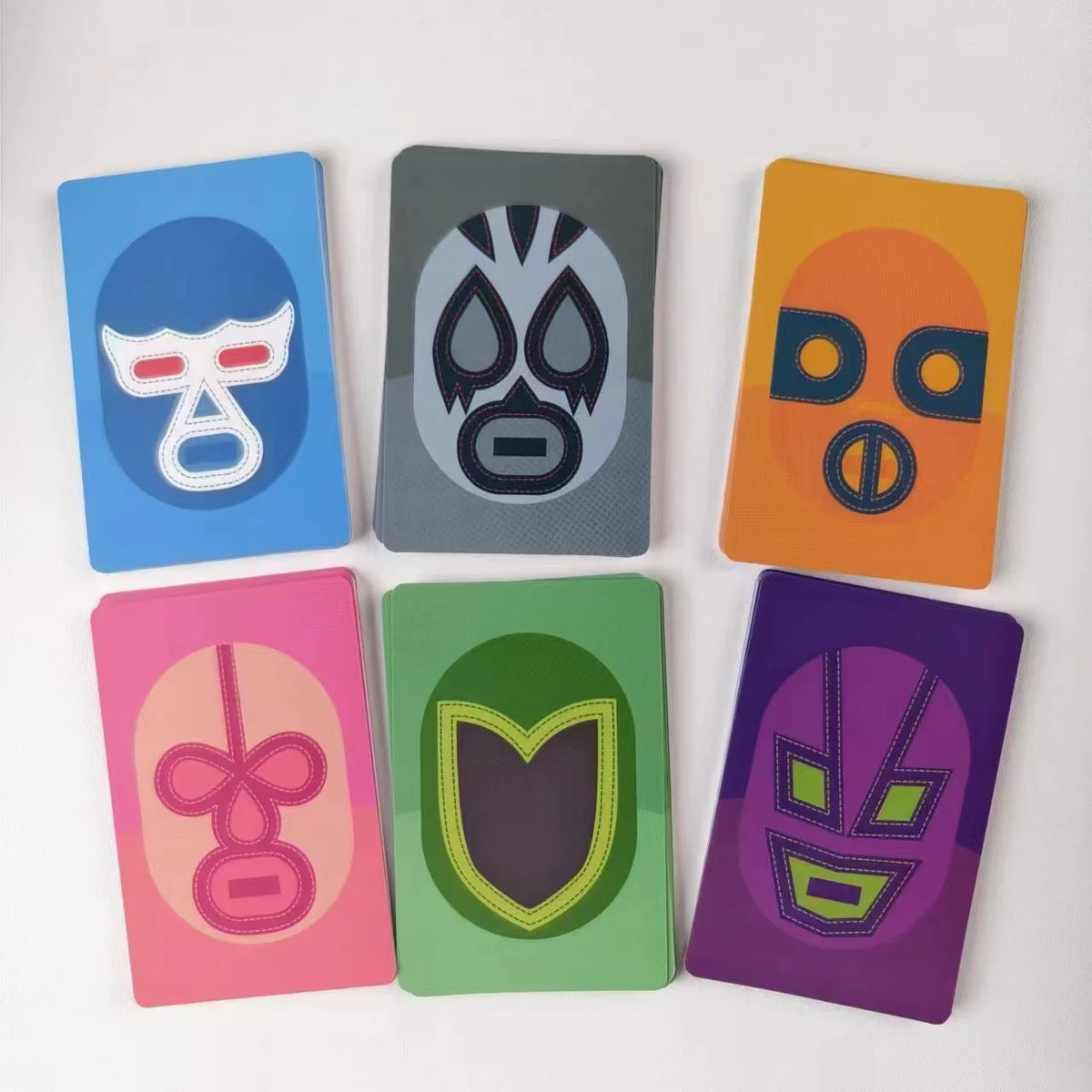 A collection of nine colorful, rectangular strategy game boards featuring stylized animal or abstract faces.