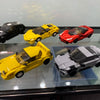 A display of various yellow, red, and gray classic supercar building blocks set for adults.