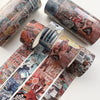 A collection of vintage patterned washi tape rolls in various colors and designs for crafting.