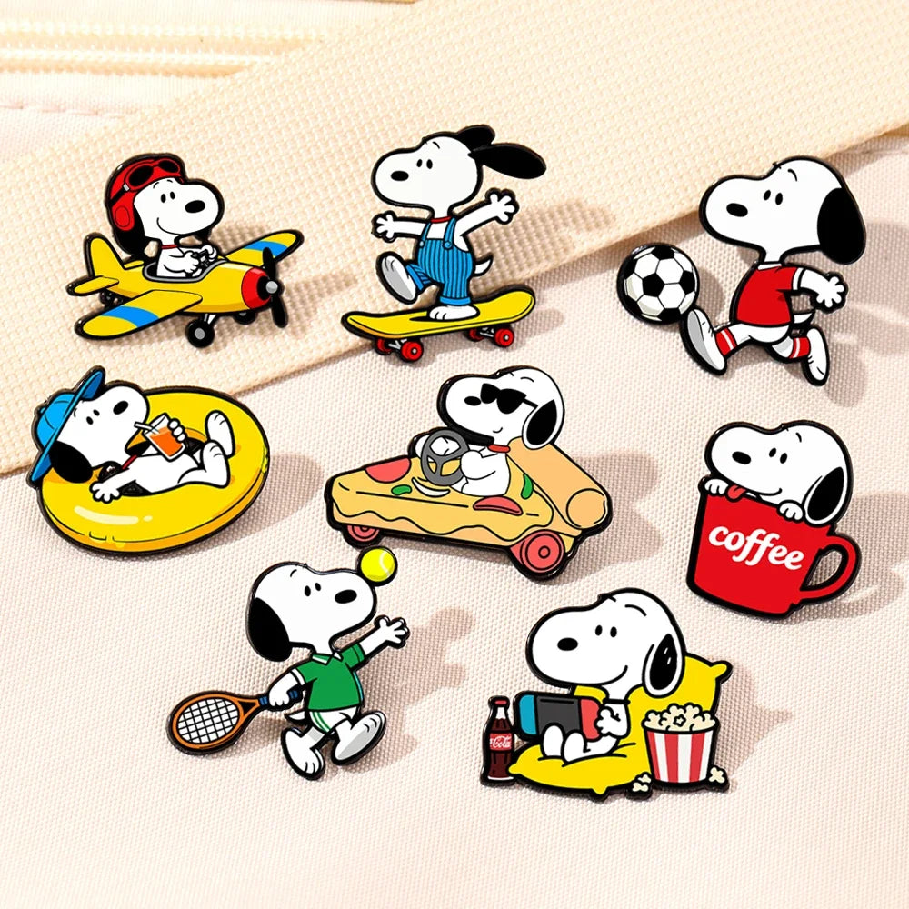 A set of seven Snoopy enamel pins featuring various cartoon characters in different poses and themes.