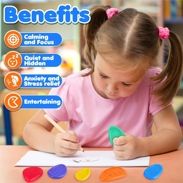 A young girl is using a set of six colorful worry stones to draw on paper for sensory and focus activities.