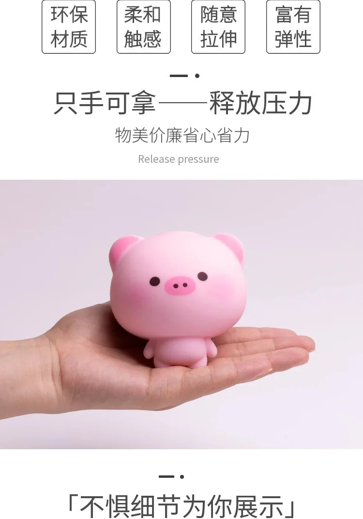 A hand is holding a pink squishy pig stress relief toy.