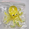 A yellow squishy toy shaped like an octopus is sealed in a clear plastic bag.