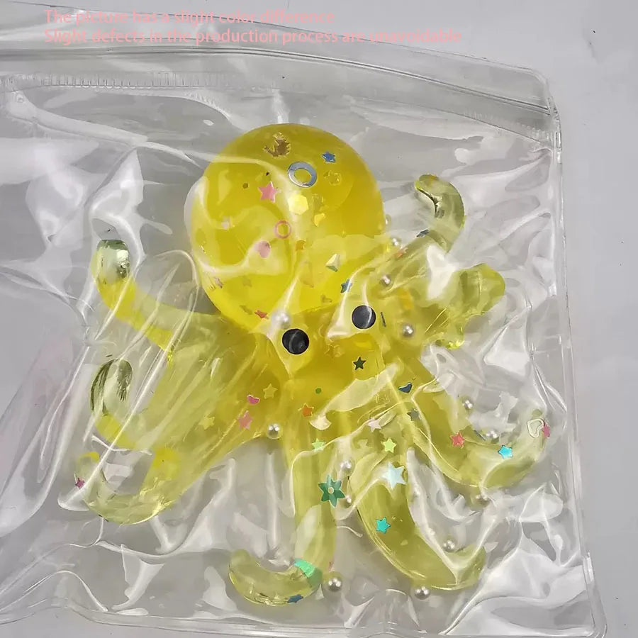 A yellow squishy toy shaped like an octopus is sealed in a clear plastic bag.
