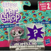 A package of Littlest Pet Shop figures, including a purple and white animal figure, is displayed against a colorful backgroun