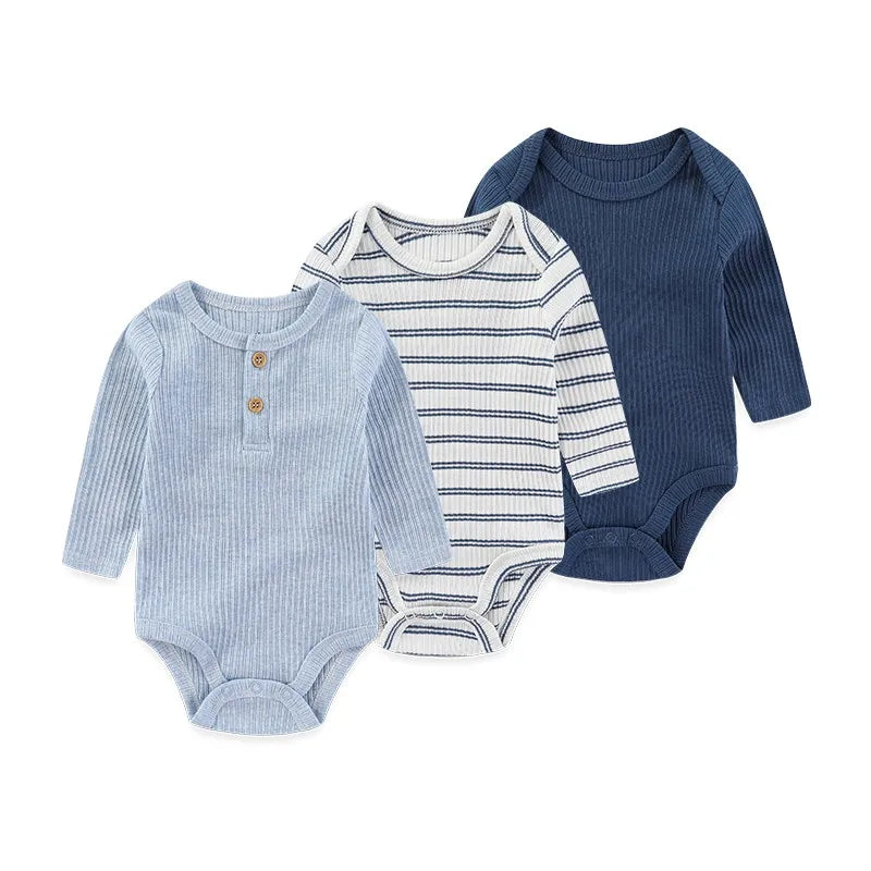 A set of three cotton baby bodysuits with long sleeves in light blue, white stripes, and navy blue.