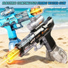 A blue and black electric water gun is shown firing a yellow stream on a sandy beach.