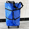 A bright blue foldable shopping bag with black straps is shown standing on a wheeled cart.