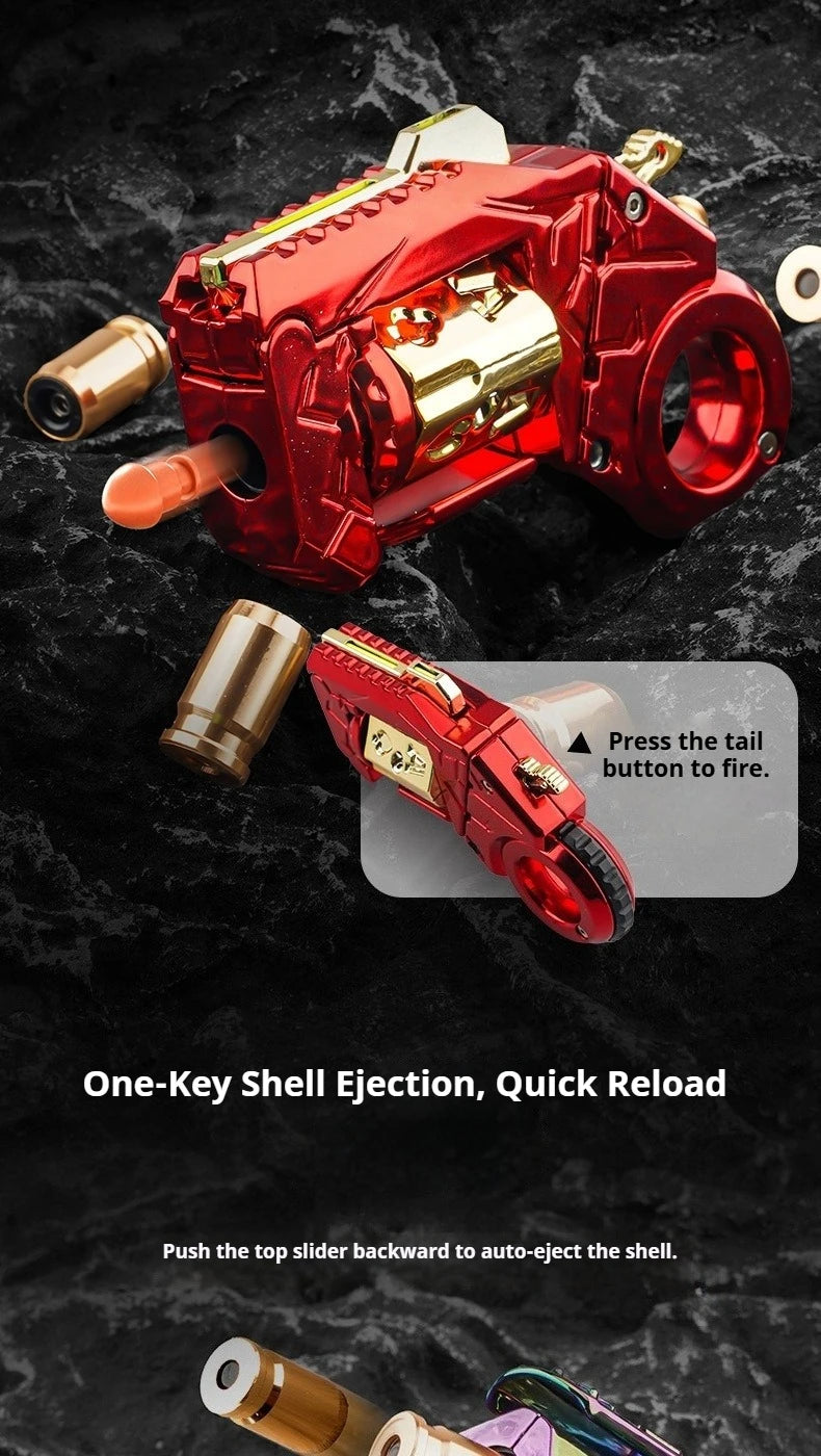 A red metal gun-shaped fidget slider with a gold barrel and a sliding mechanism for quick reload.