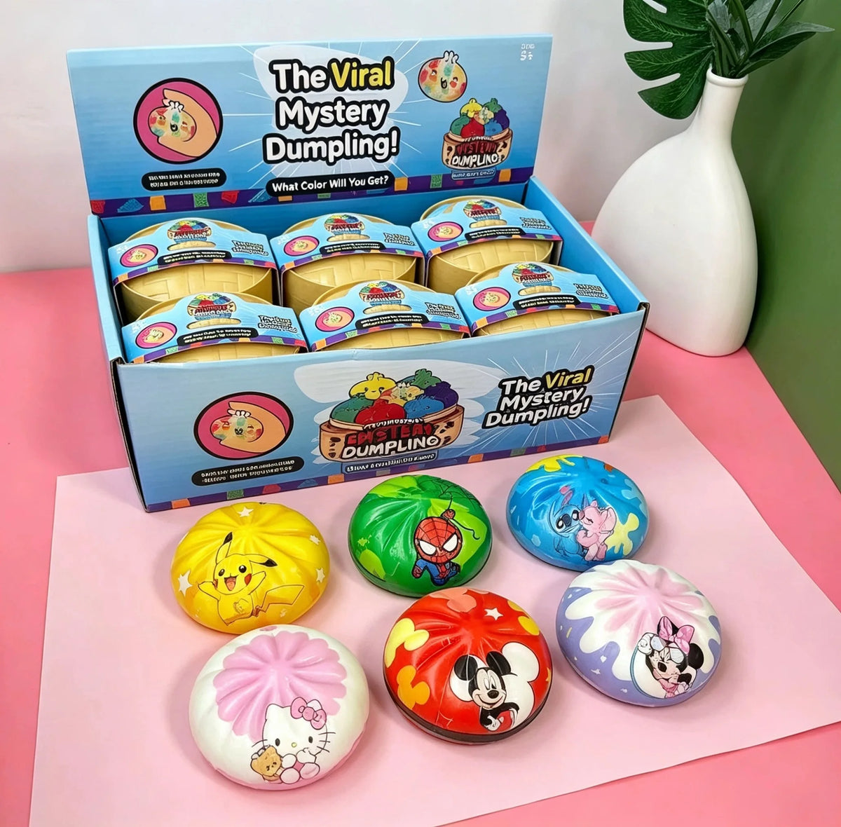 A box of The Viral Mystery Dumpling squishies featuring various cartoon characters and colors.