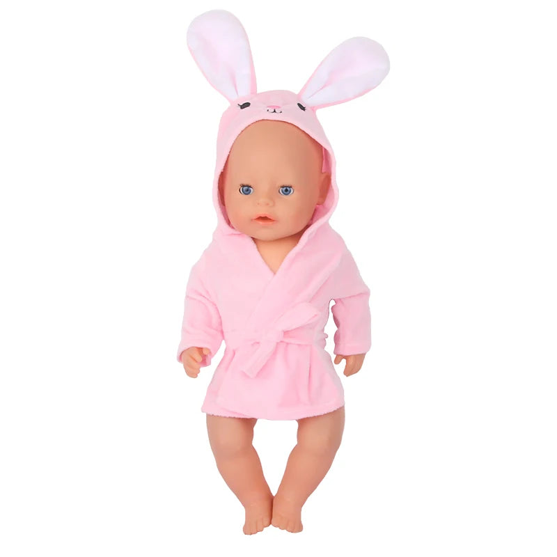 A baby doll wearing a pink cartoon animal bathrobe and nightgown set.